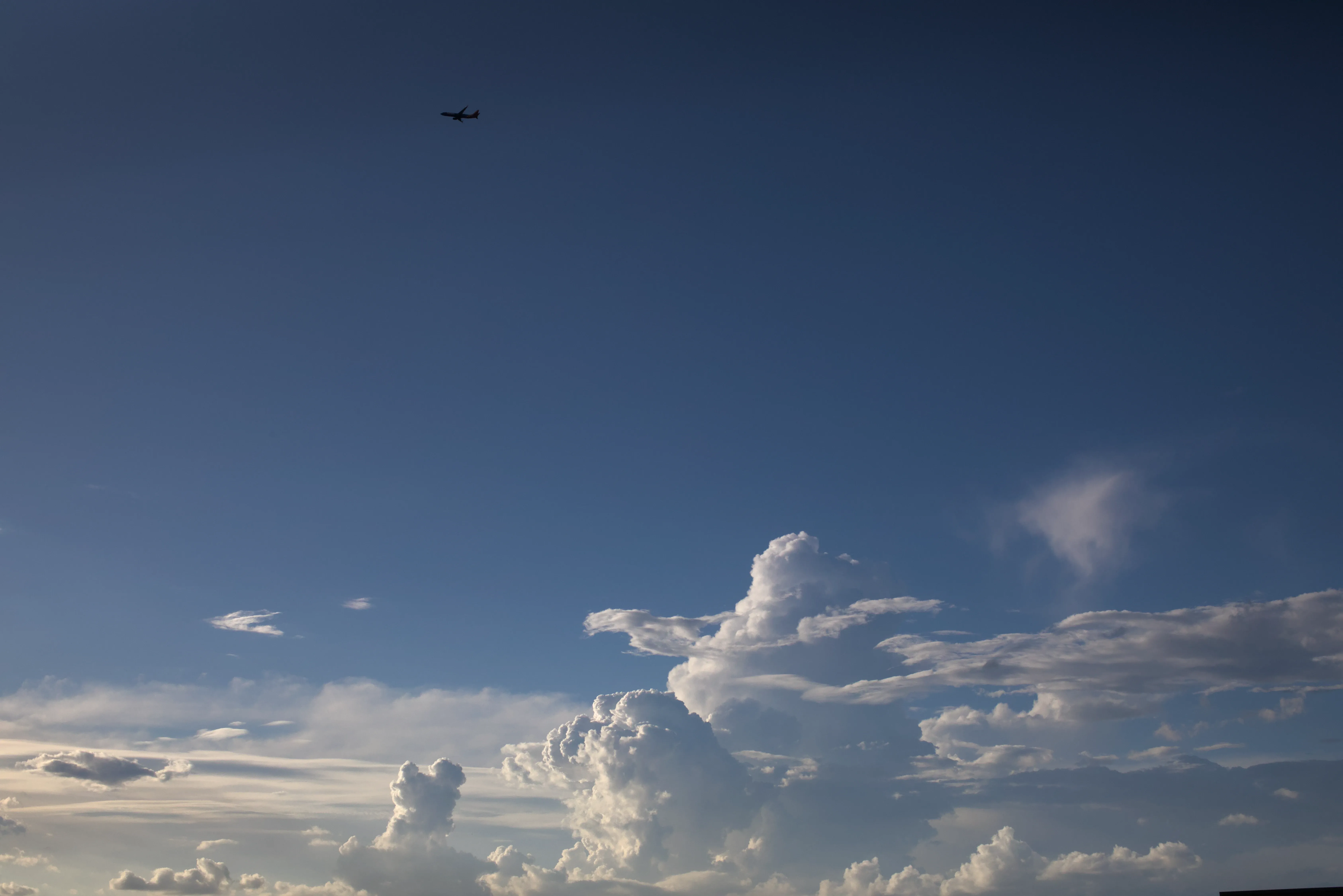 A plane flys above the clouds