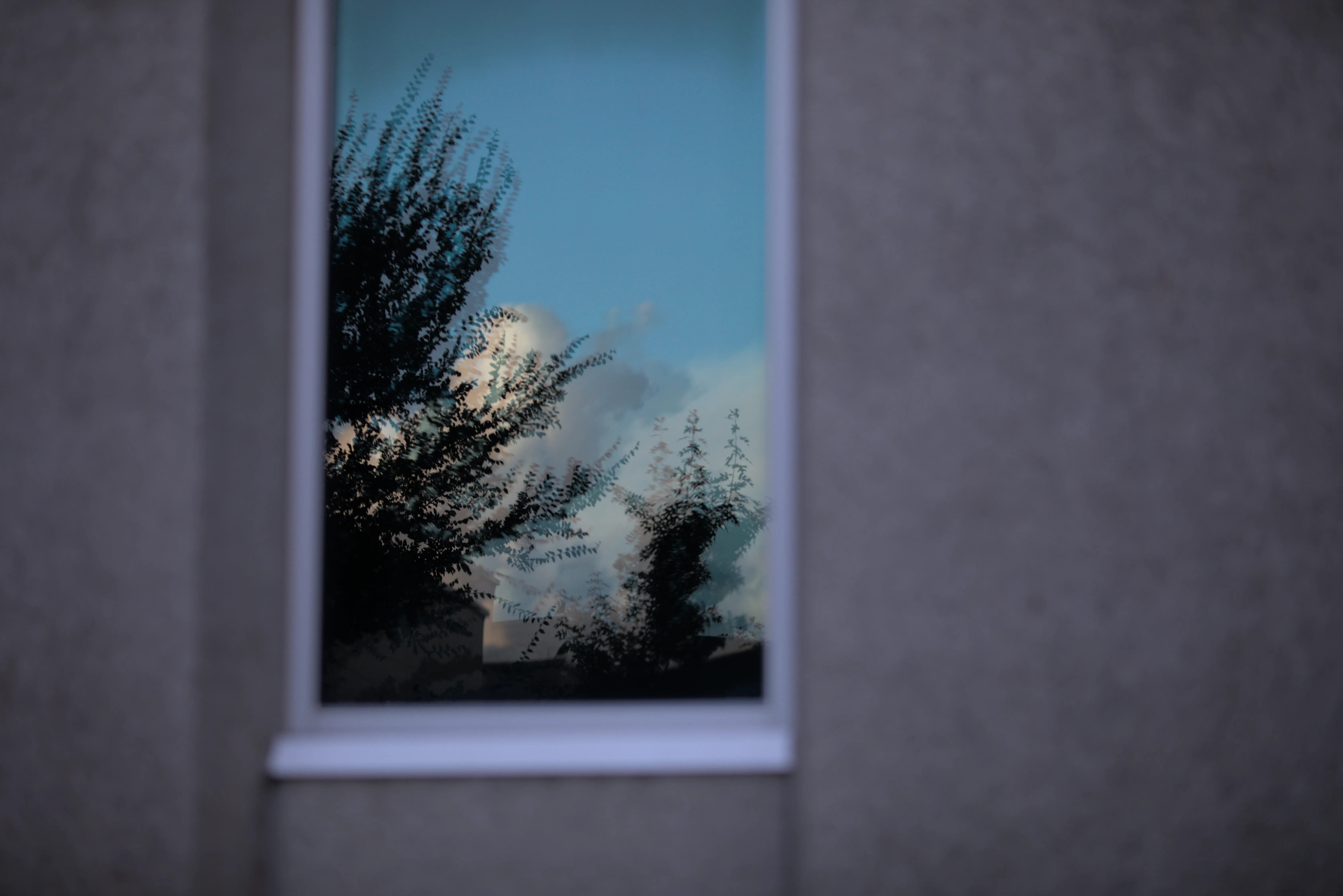 The sky is imperfectly reflected off a window