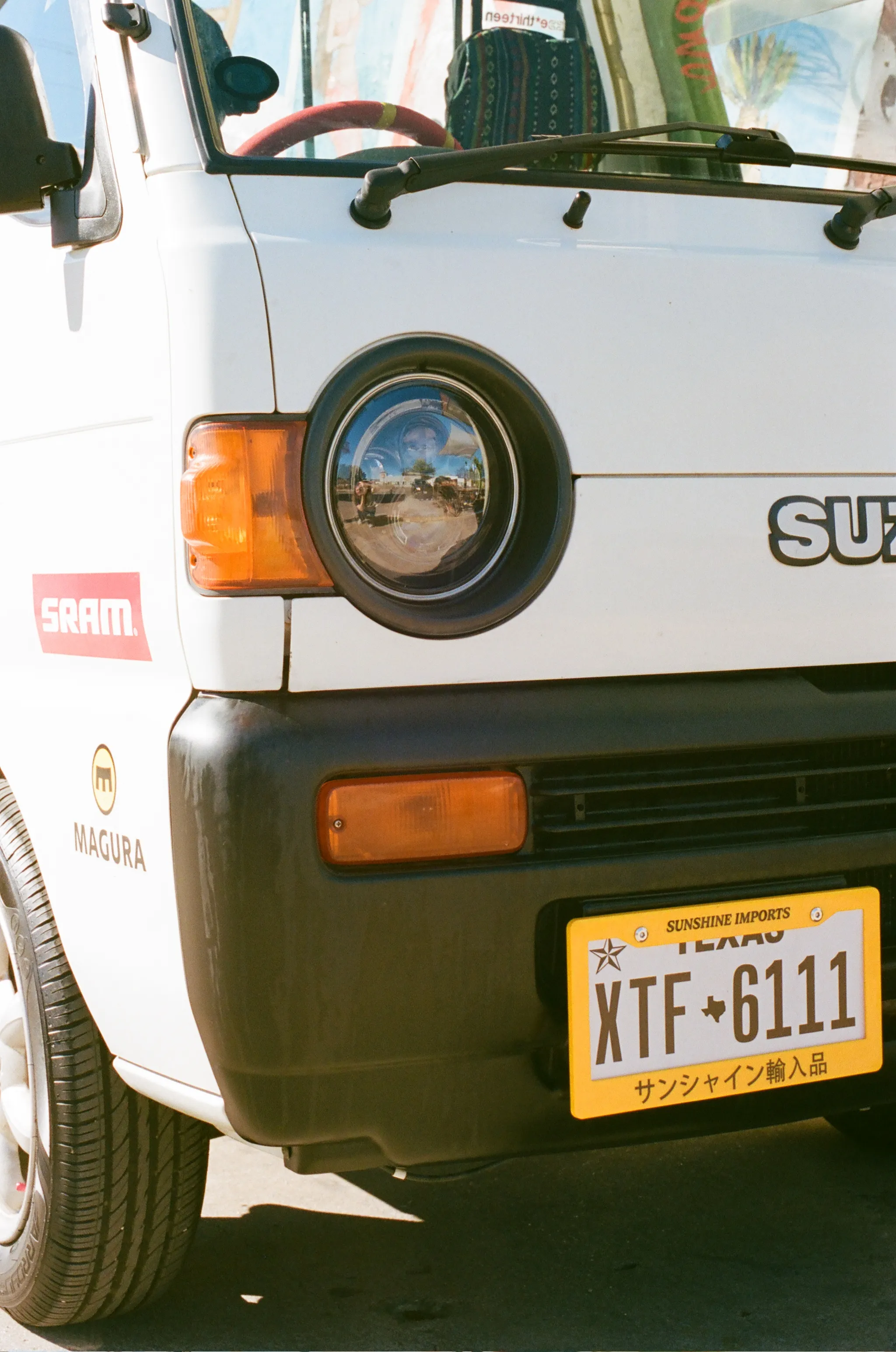 The front right side of a Suzuki kei truck