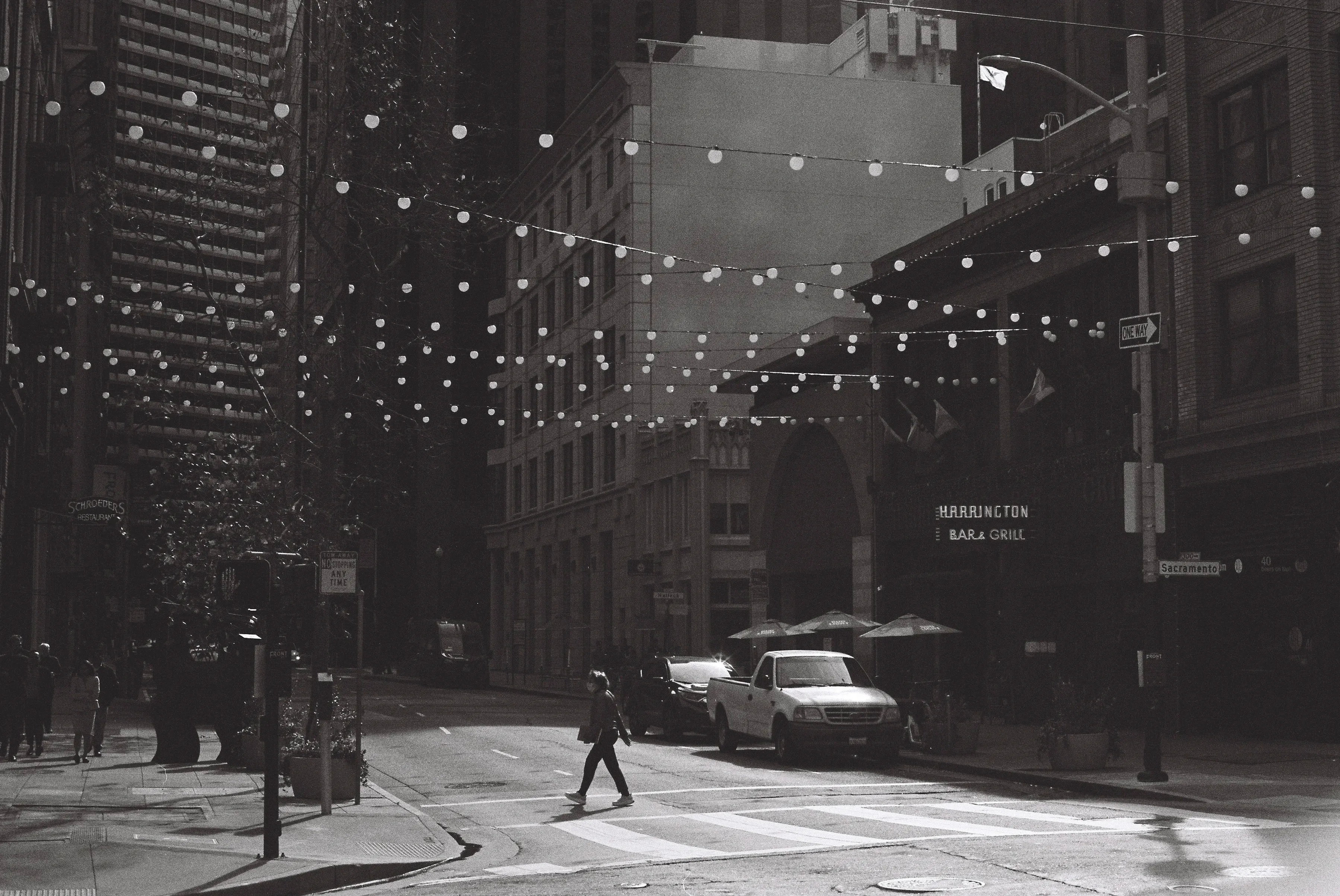 Canyonous financial district street, with lights strong between the buildings