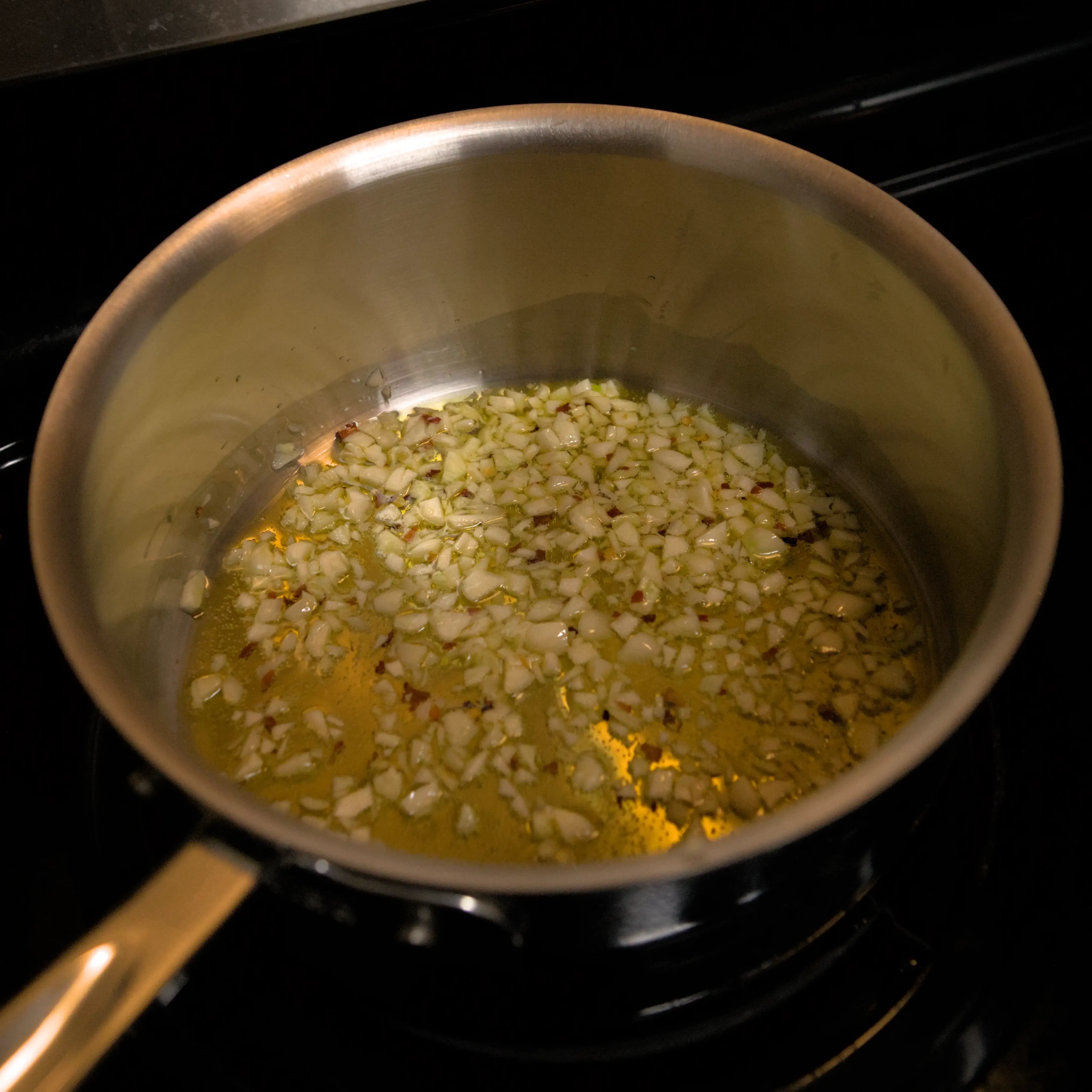 Sauce pan with oil, garlic, and red pepper flakes